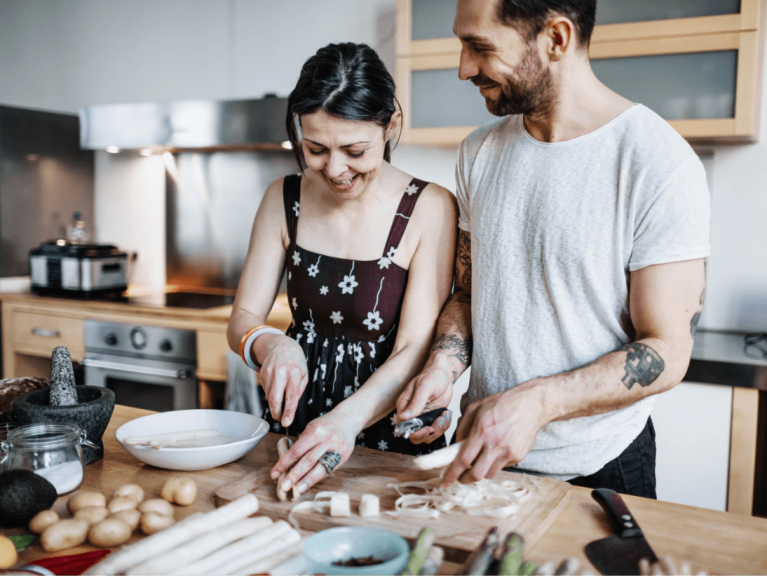 Paar beim gemeinsamen Kochen mit frischem Gemüse